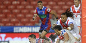 Dylan Lucas scores in the Newcastle slush for a try.