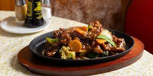 A skillet of sizzling Mongolian beef.