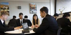 Ashfield Boys High senior study teacher Rachel Bennett with year 11 students. 