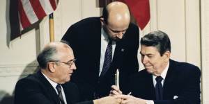 US President Ronald Reagan,right,and Soviet leader Mikhail Gorbachev exchange pens during the Intermediate Range Nuclear Forces Treaty signing ceremony in the White House in 1987. 