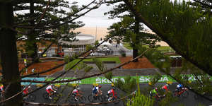 Riders in the under-19 road race travel along the coast in Wollongong on Friday.