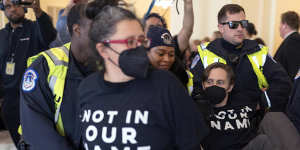 US Capitol Police officers detain a demonstrator protesting inside the Cannon House Office Building on Capitol Hill in Washington.