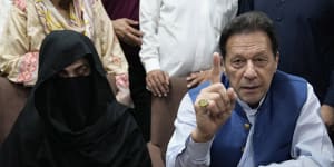akistan’s former Prime Minister Imran Khan,right,and Bushra Bibi,his wife,talk to the media in July 2023.