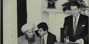 November 12,1987:US president Ronald Reagan tells a White House audience that mujahideen leader Yunus Khalis (left) represents"a nation of heroes". Translating for Khalis is State Department official Zalmay Khalilzad,later the Trump administration's envoy to Afghanistan.