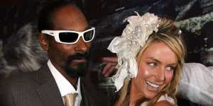 Suited rapper Snoop Dogg with model Jennifer Hawkins. “The party vibe went up 100 per cent” when he arrived at a Birdcage marquee,recalls an organiser.