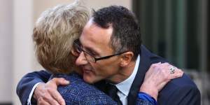 Former Greens leader Christine Milne embraces new Greens leader Richard Di Natale during a press conference in Parliament House in May 2015.