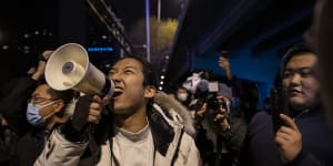 A protester in Beijing shouts slogans during a protest against China’s strict zero-COVID measures.