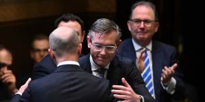 NSW Premier Dominic Perrottet hugs Treasurer Matt Kean after his budget address on Tuesday.