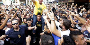 Jair Bolsonaro is taken on the shoulders of a supporter moments before being stabbed during a campaign rally in Juiz de Fora,Brazil.