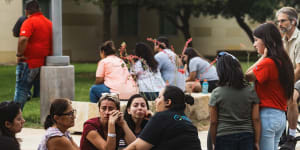 People grieve outside the SSGT Willie de Leon Civic Centre after a school shooting in Texas. 