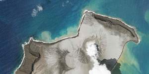 A an island created by the underwater Hunga Tonga Hunga Ha’apai volcano is seen smoking on January 7.