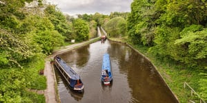 Narrowboats in the Llangollen Canal,built by Thomas Telford,manoeuvering before crossing the Chirk Aqueduct.