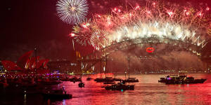 Spectator boats in Sydney Harbour look on as New Year's Eve fireworks erupt over the Sydney Harbour Bridge.