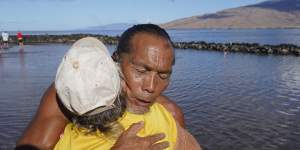 Vicente Ruboi receives a hug after performing a blessing to greet the day in Kihei,Hawaii.