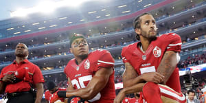 Colin Kaepernick,right,and Eric Reid take a knee during the US national anthem in 2016.