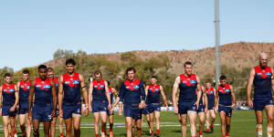 The dejected Demons traipse off Traeger Park in Alice Springs after Sunday’s 92-point loss. 