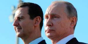 Russian President Vladimir Putin,right,and Syrian President Bashar Assad watch troops marching at the Hemeimeem air base in Syria in 2017.