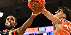 Bryce Cotton of the Wildcats goes to the basket against Cairns.