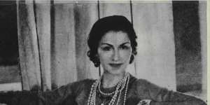 Company founder Coco Chanel wearing her famous string of pearls,October 1956.