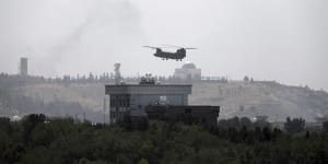 A US Chinook helicopter flies over the American embassy in Kabul,Afghanistan on Sunday.