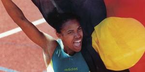 Cathy Freeman famously carries the Aboriginal flag alongside that of Australia at the 1994 Commonwealth Games in Canada.