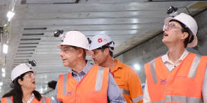Deputy Premier Cameron Dick,State Development Minister Grace Grace and Transport Minister Bart Mellish tour the Albert Street station’s now-constructed platform and mezzanine level above.