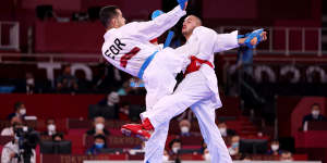 Steven Da Costa,right,of France competes against Hamoon Derafshipour of the IOC Refugee Team during the men’s karate kumite -67kg elimination round on Thursday.