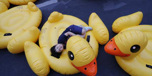 A boy lies on an inflatable yellow duck,a symbol of the protest movement,during a rally in Bangkok in 2020.