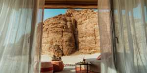 Arabian carpets and low couches five way to the red sandstone cliffs of the canyon.