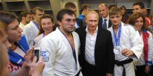 Russian President Vladimir Putin,centre right,poses for a photo with athletes while attending the Judo World Cup in the city of Chelyabinsk in Siberia,Russia.