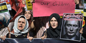 Demonstrators in Istanbul hold placards and a picture depicting"Killer Putin"during a protest against Russian military operations in Syria in October 2015.