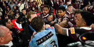 Cameron Murray runs into a sea of Maroons players to fight from the bench.