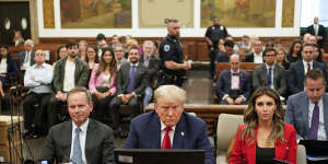 Former President Donald Trump,centre,sits in the courtroom with his legal team in the New York Supreme Court.