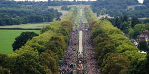 Crowds at Windsor watch as the Queen’s hearse appraoches the castle. 