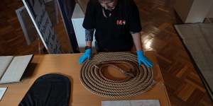 Staff from the Museums of History NSW unload exhibits including a noose,black hood worn by the condemned and a letter from Louisa Collins.