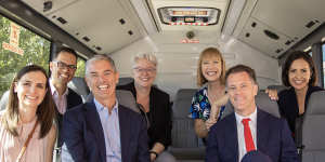 NSW State Labor leader Chris Minns (right,front) joins members of his leadership team on the campaign bus on Sunday.