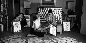 Grace Kelly and Edith Head look over sketches for To Catch a Thief (1955). 