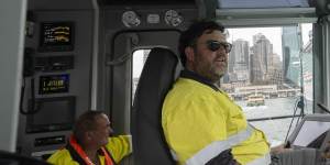 Tug master Dom McCarron with deckhand Dave Barringer on the Engage Rascal tug in Sydney Harbour.