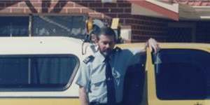 Malcolm Harris with his patrol car.
