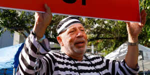 A protestor holds a “Lock Him Up” sign outside the Wilkie D. Ferguson Jr. United States Courthouse in Miami,Florida,