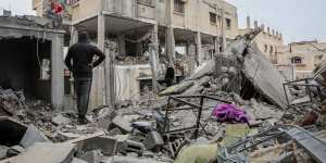 People inspecting the damage and recovering items from their homes following Israeli air strikes in Rafah.