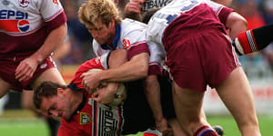 North Sydney enforcer Billy Moore is driven into the Brookvale turf by Manly’s Des Hasler in 1995.