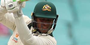 Usman Khawaja drives through covers.