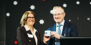 Reserve Bank governor Philip Lowe hands his successor,Michele Bullock his optimistic coffee mug.