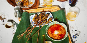 Satay sauce served alongside pork satay skewers.