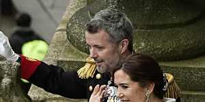 King Frederik X and Queen Mary wave to the crowd from the balcony of Christiansborg Palace.