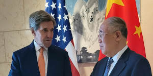 US envoy John Kerry shakes hands with his Chinese counterpart Xie Zhenhua before a meeting in Beijing on Monday.