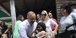 Prime Minister Anthony Albanese embraces a child after his Garma keynote speech.