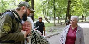 A serviceman of Donetsk People’s Republic militia embraces a local woman in Svitlodarsk,in territory under the government of the Russia-backed Donetsk People’s Republic,in eastern Ukraine,