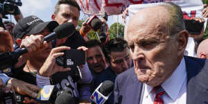 Rudy Giuliani speaks outside the Fulton County jail in Atlanta before being charged in relation to Trump’s attempt to overturn the 2020 election results.